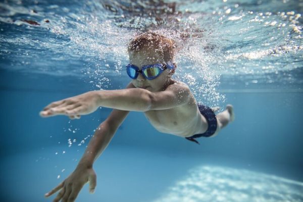 boy swimming with Goggle on
