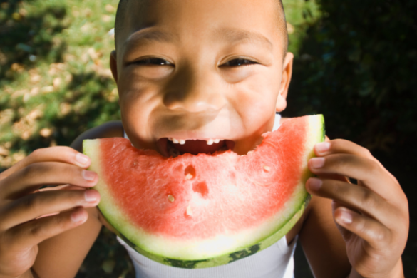 child eating watermelon