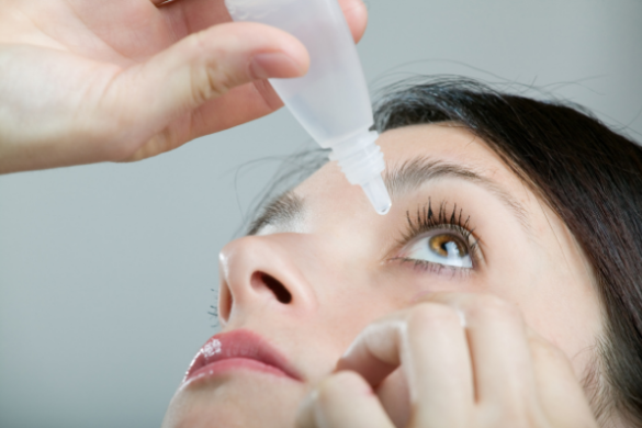 woman aplying eye drops